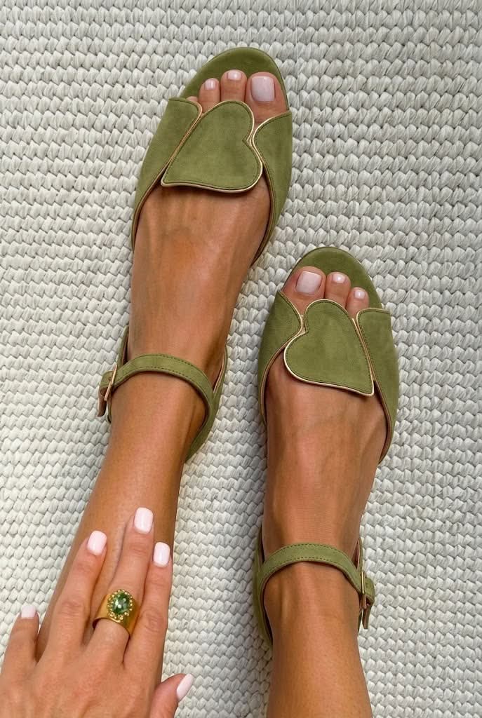 Pink open-toe sandals with ankle strap and heart motif