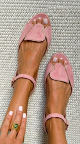 Pink open-toe sandals with ankle strap and heart motif