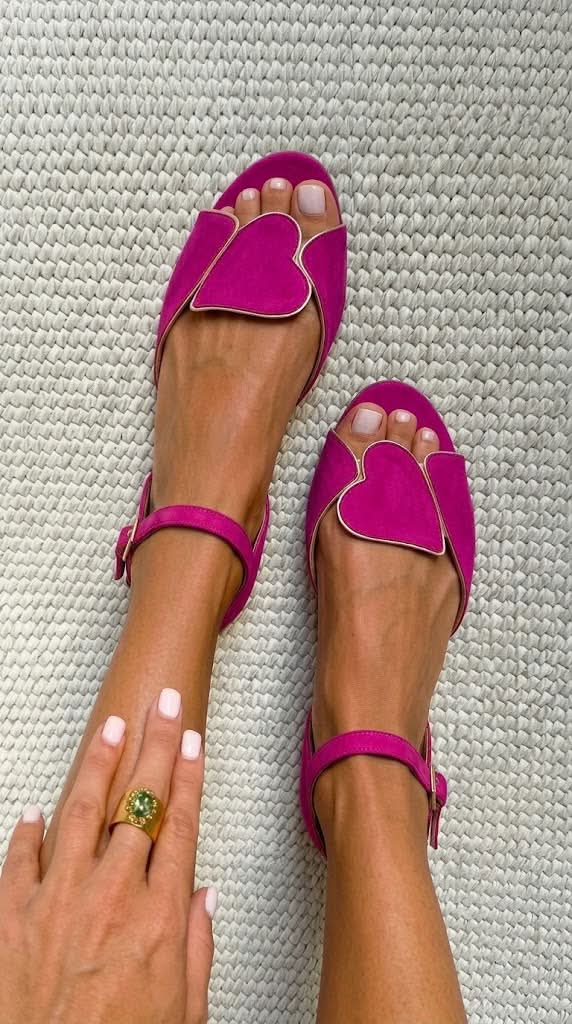 Pink open-toe sandals with ankle strap and heart motif