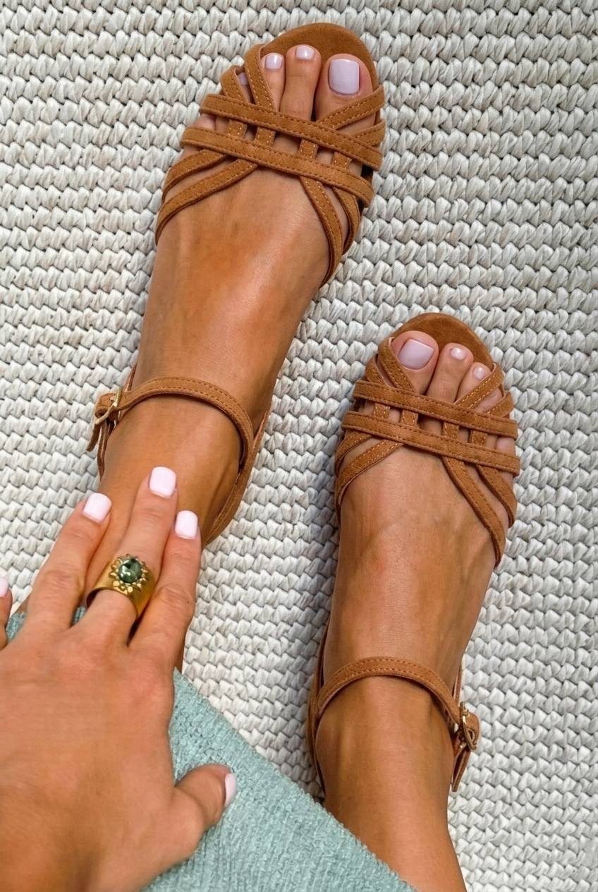 Low tan suede sandals with ankle buckle and multiple straps